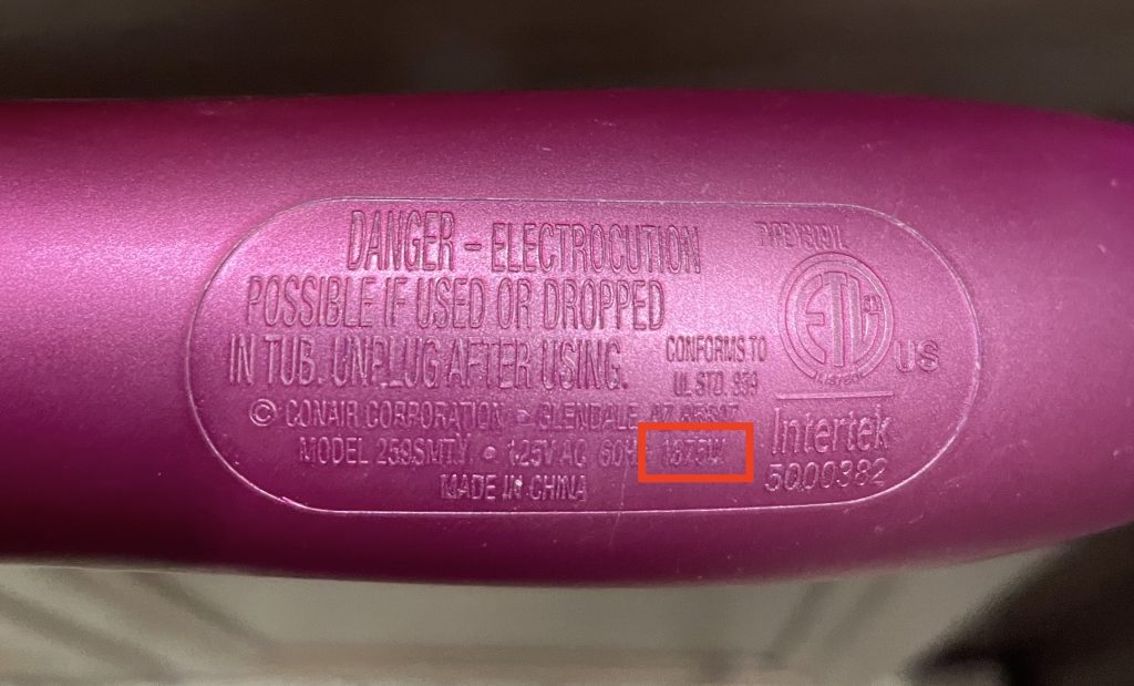 Hair dryer wattage labeled on the handle